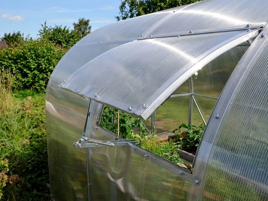 Silver greenhouse ventilation window with automatic opener