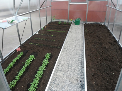 Greenhouse track separator with ground reinforcement feature
