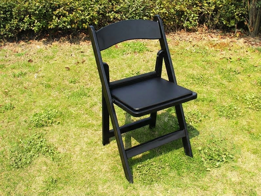 Black padded folding chairs suitable for commercial use