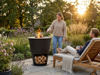 Black carbon steel fire bowl with wood storage for outdoor use - view 3