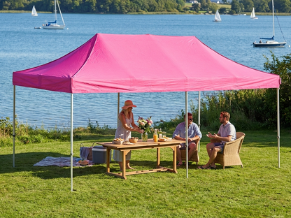 Pink pop-up gazebo with steel frame set up in an outdoor setting